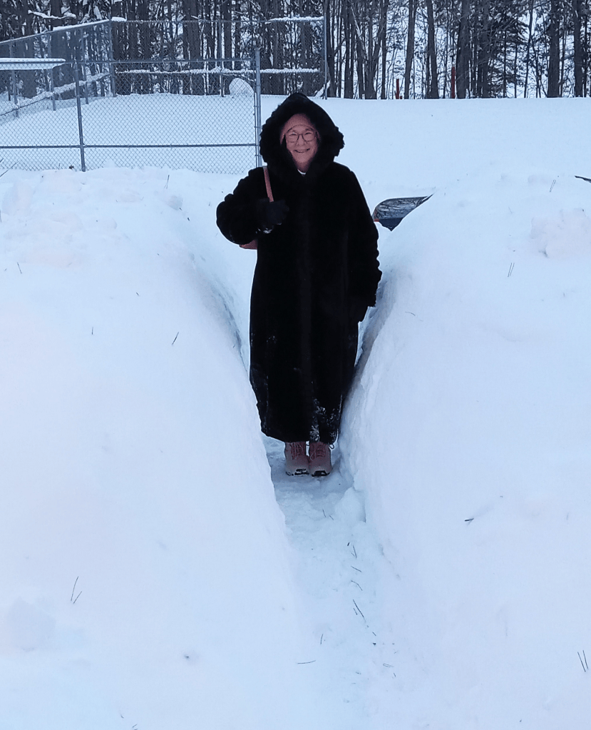 Mike heading out to watch hockey game through tunnel of snow in front yard